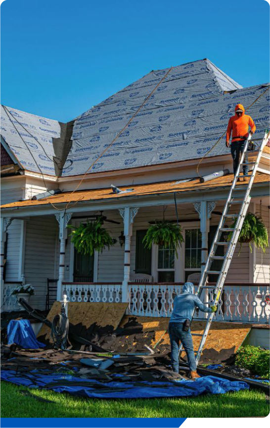 Roofers installing new underlayment shingles on residential home