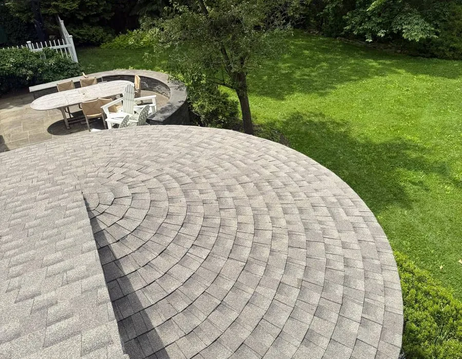 Curved turret roof with asphalt shingles installed