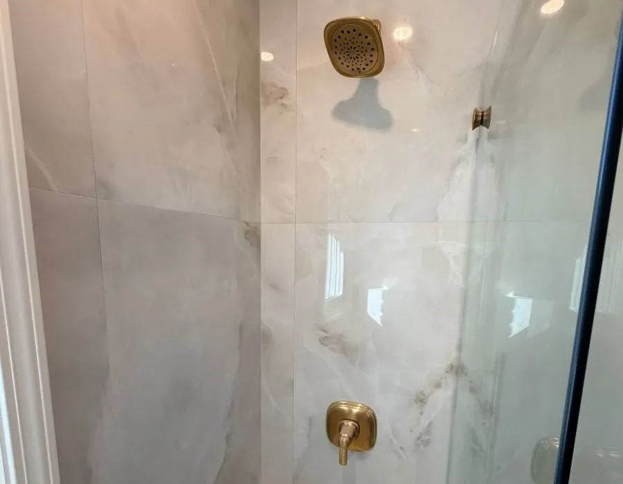 Marble shower with gold fixtures in Westchester NY