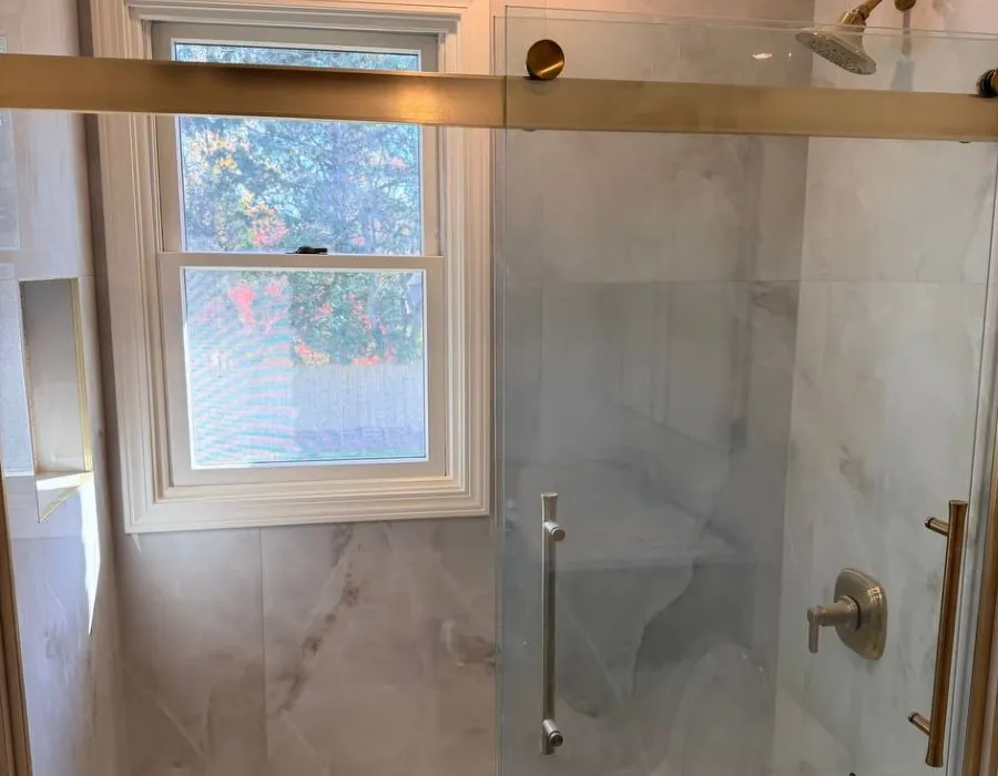 Marble shower with sliding glass door in Westchester