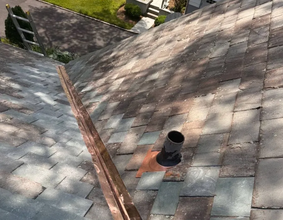 Slate roof with copper valley flashing pipe boot repair in Westchester County